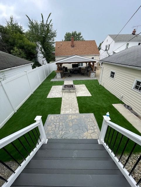 A backyard with stairs leading to the back yard.